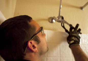 Plumber in Citrus Heights repairs a shower head